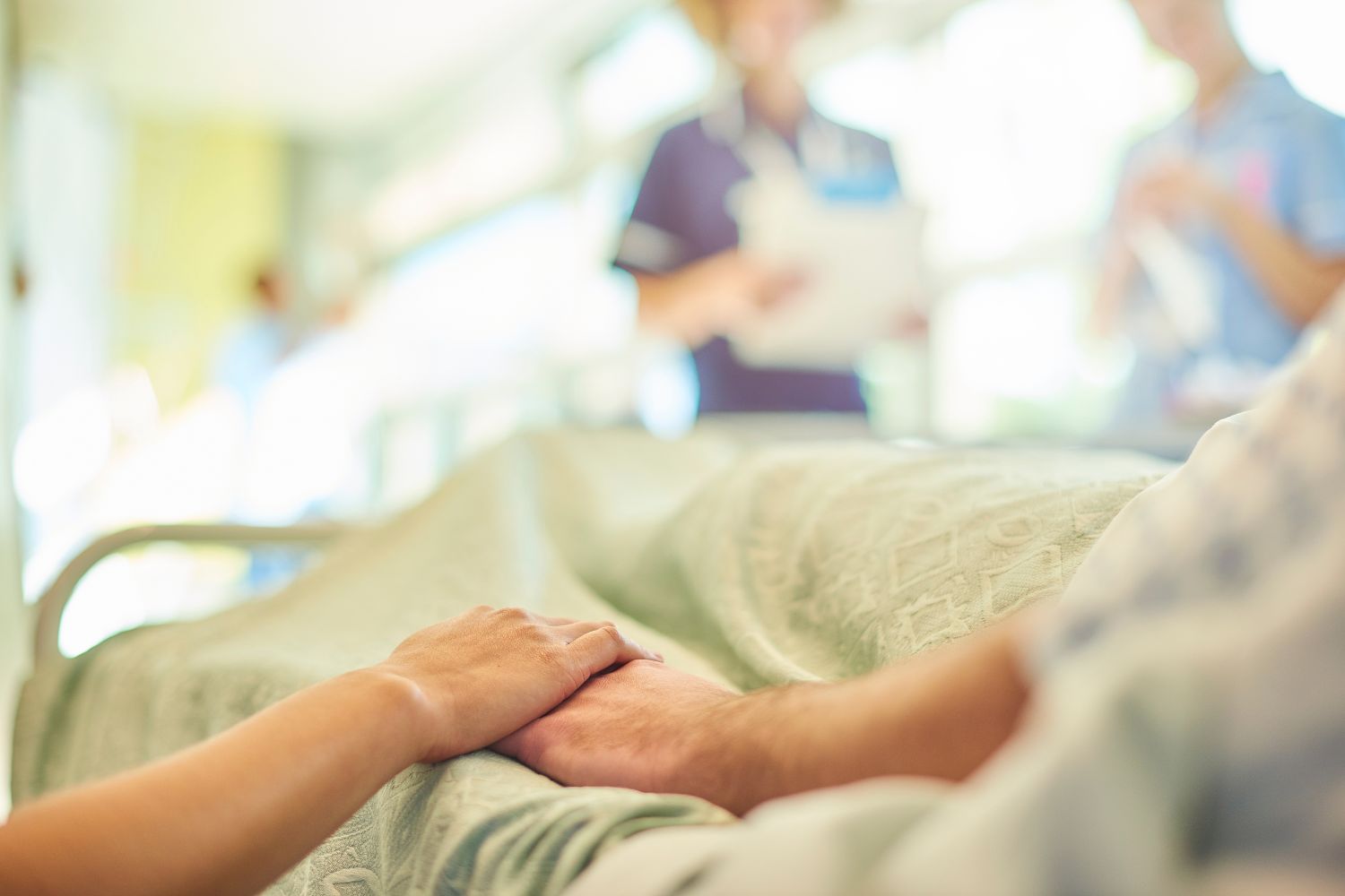 people holding hands at a hospital